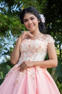 Portrait of a smiling young woman standing outdoors