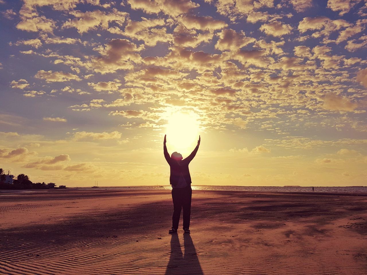 sunset, sky, sun, tranquil scene, nature, beauty in nature, scenics, real people, cloud - sky, one person, tranquility, silhouette, standing, leisure activity, sunlight, outdoors, lifestyles, landscape, women, yoga, sand, beach, sea, full length, water, day, people