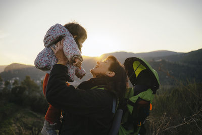 Spain, barcelona, grandmother with granddaughter during a hike at sunset