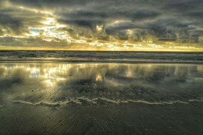 Scenic view of sea against cloudy sky