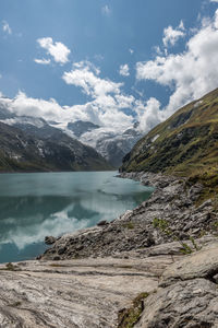 Scenic view of lake and mountains against sky