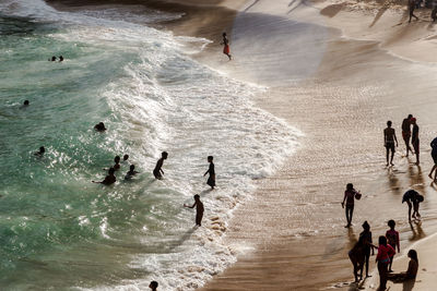 High angle view of people enjoying at beach