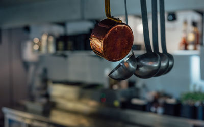 Close-up of utensils hanging in kitchen