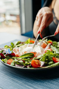 Midsection of man preparing food in plate