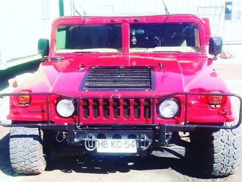 Red vintage car on bus