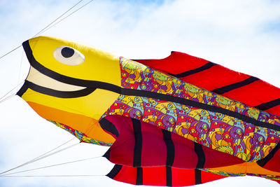 Low angle view of multi colored umbrella against sky