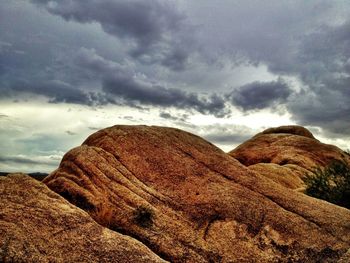 Scenic view of mountains against cloudy sky