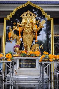 Statue of buddha against building