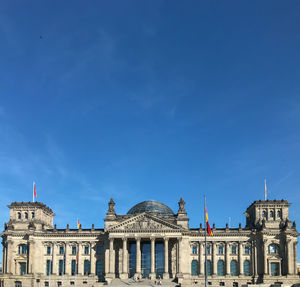 Low angle view of reichstag building against blue sky