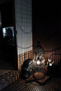 Shadow of man lying on illuminated floor at home