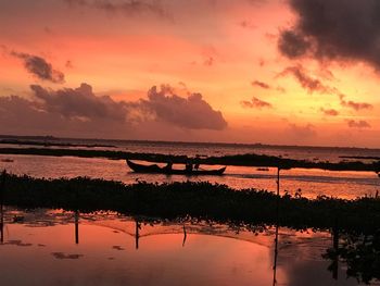 Scenic view of sea against orange sky