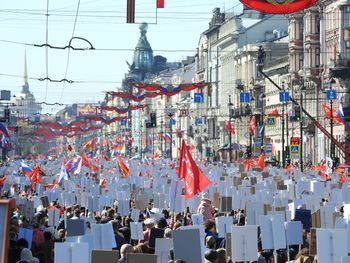 Group of people on street against buildings in city