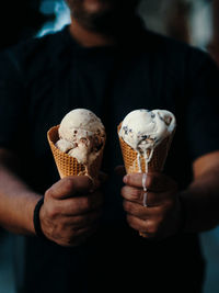 Midsection of man holding ice cream