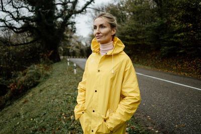 Young woman standing on road