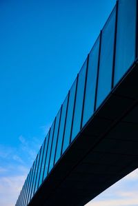 Low angle view of bridge against clear blue sky