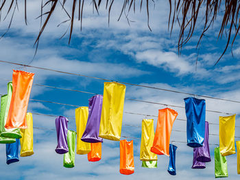 Low section of woman standing against blue sky