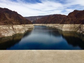 Scenic view of lake mead behind hoover dam against sky