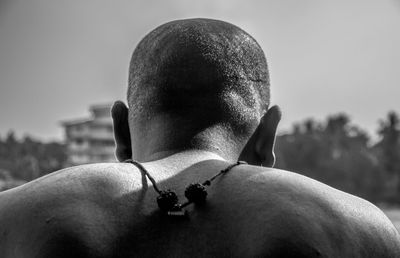 Rear view of shirtless bald man