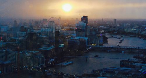 High angle view of buildings in city against sky during sunset