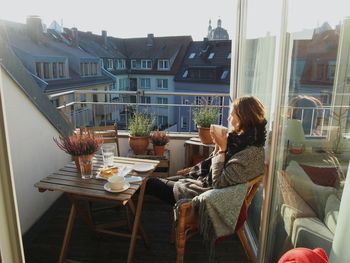 Midsection of woman sitting on table