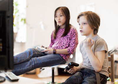 Boy and girl playing video game