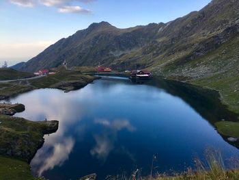 Scenic view of lake and mountains against sky