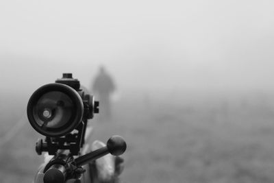 Close-up of coin-operated binoculars against sky