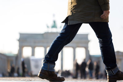 Low section of person walking on footpath