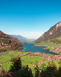 Scenic view of bay against clear blue sky