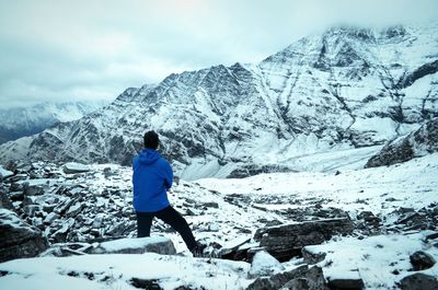 Woman standing on snow covered landscape