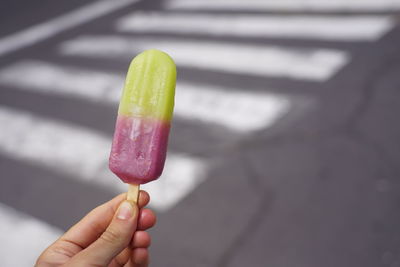 Close-up of hand holding ice cream cone