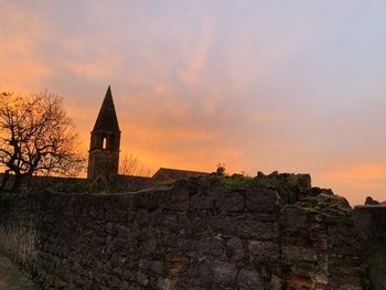 Historic building against sky during sunset