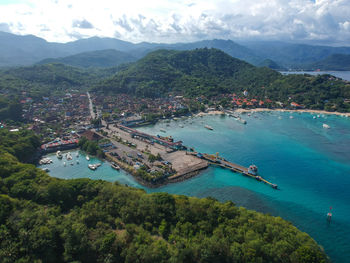 High angle view of boats in sea against mountains