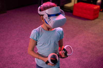 Vr game and virtual reality. kid girl gamer eight years old fun playing on simulation video game