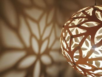 Illuminated lantern with shadow on wall
