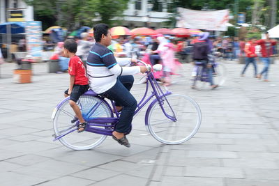 Man riding bicycle on city street