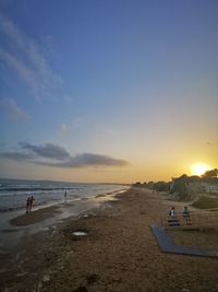 Scenic view of beach against sky during sunset