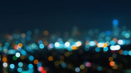 Defocused image of illuminated lights at night