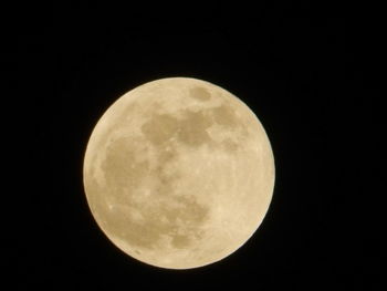 Low angle view of full moon against clear sky at night