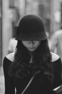 Front view of woman with obscured face in city