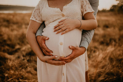 Midsection of woman holding hands