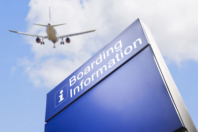 Low angle view of airplane flying against sky