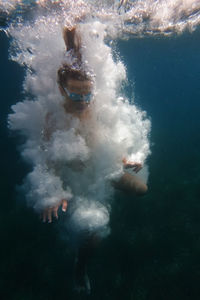 High angle view of man swimming in sea