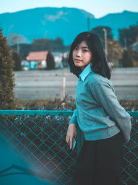 Portrait of young woman standing outdoors