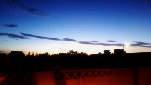 Silhouette of trees against cloudy sky