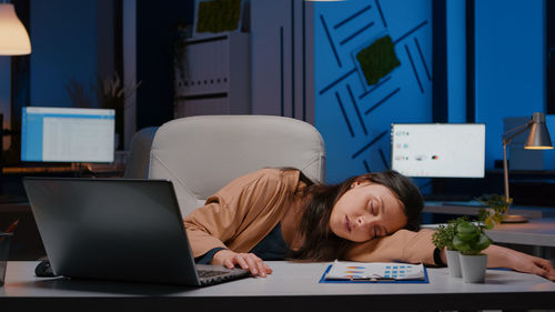 Woman sleeping on office desk
