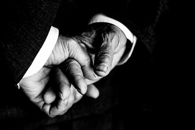 Close-up of man hands against black background