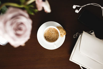 High angle view of coffee and cup on table