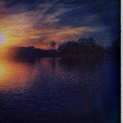 Scenic view of lake at sunset