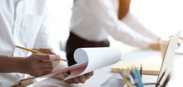 Low section of people working on paper